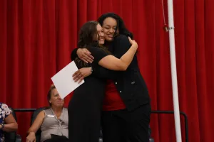 A nursing graduate receiving an award at the Practical Nursing pinning ceremony.