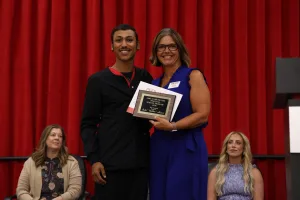 A nursing graduate receiving an award at the Practical Nursing pinning ceremony.
