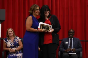 A nursing graduate receiving an award at the Practical Nursing pinning ceremony.