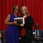 A nursing graduate receiving an award at the Practical Nursing pinning ceremony.