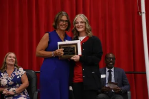 A nursing graduate receiving an award at the Practical Nursing pinning ceremony.