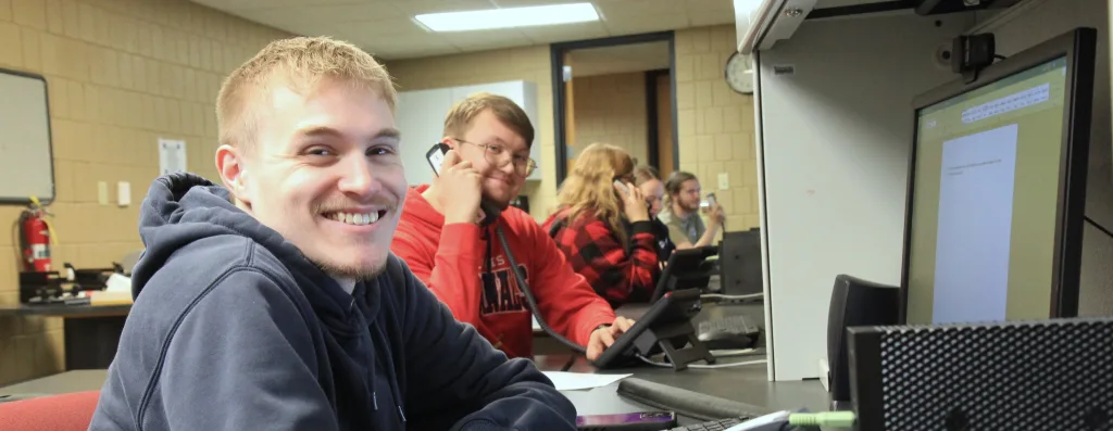 A photograph of management students working in a computer lab.