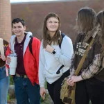 A group of students walking together on campus.