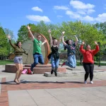 A group of students jumping in celebration.
