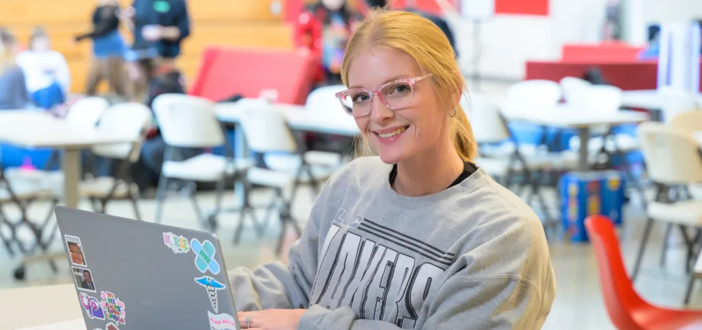 A photograph of an adult student working on a computer.