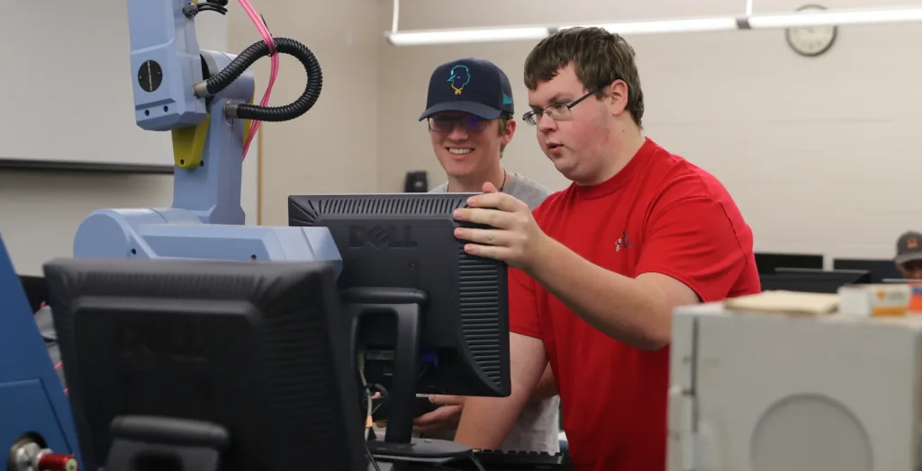 Two students working at a computer.