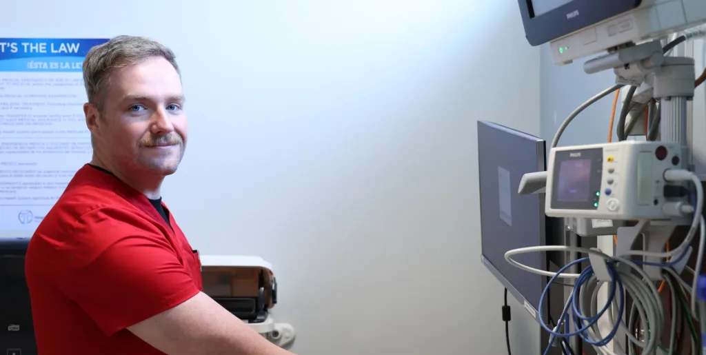 A photograph of a nursing student using a computer.