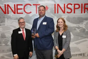 A Lake Land College alumnus receiving the Distinguished Alumnus Award during the College's annual Foundation & Alumni Awards banquet. The alumnus is posed next to Lake Land College President Josh Bullock and Director of Annual Giving and Alumni Relations Bailey Cole.