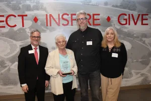 The family of a deceased Lake Land College retiree accepting an award during the College's annual Foundation & Alumni Awards ceremony.