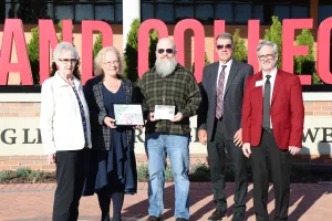 The family of Mike Sullivan accepting an award during the Sullivan Plaza dedication ceremony.